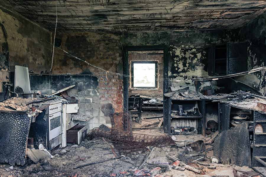 a burnt room demonstrating property damage, from pexels user F. Hektor